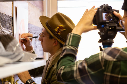 A man is taking a picture of another man with a camera