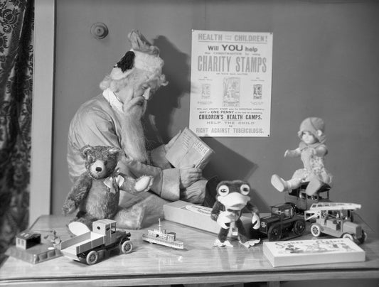Dolls and toys displayed with a poster